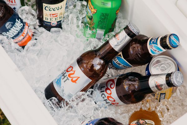 Beer bottles in cooler with ice